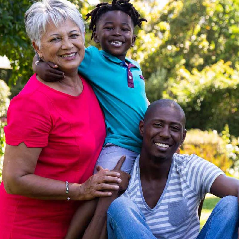 Smiling Grandmother, Son, and Grandson outside - Carolina Counseling Greenville, NC offering Family Counseling