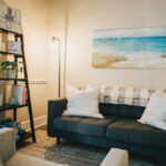 Inside picture of black couch with pillow and seascape, Carolina Counseling located in Greenville, NC