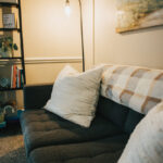 Inside picture of black couch with pillow and seascape, Carolina Counseling located in Greenville, NC