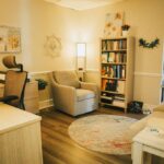 Inside picture of light colored couch with pillow and seascape, Carolina Counseling located in Greenville, NC