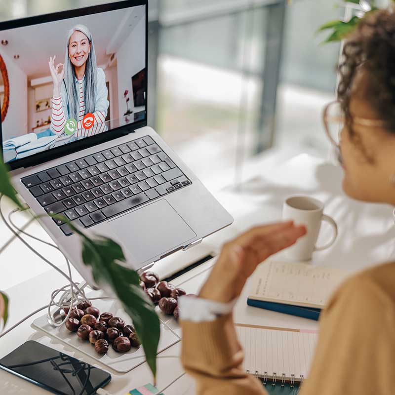 Adult woman speaking to woman on computer - Carolina Counseling NC